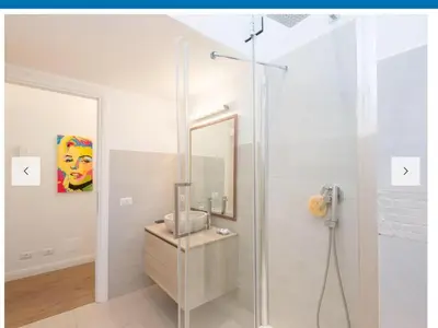 a bathroom with a shower with a sink and a mirror at Natale del Grande flat in Rome