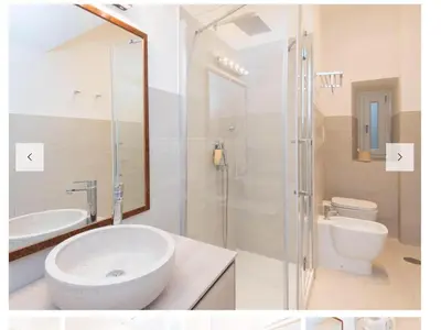 a bathroom with a sink and a shower and a toilet at Natale del Grande flat in Rome