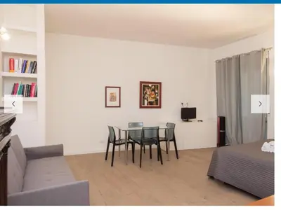 a living room with a table and chairs and a couch at Natale del Grande flat in Rome