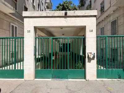 an entrance to a building with a green gate at Sant'Erasmo Rooms in Rome