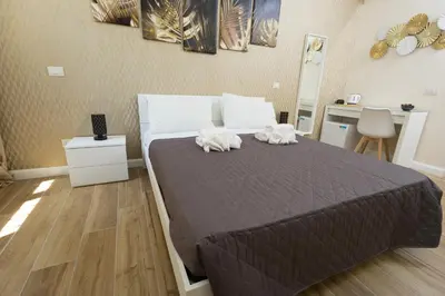 a bedroom with a bed with two towels on it at Sant'Erasmo Rooms in Rome