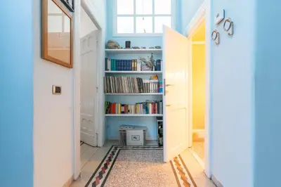 a hallway with a book shelf with books at Residenza Prati - ZEN24 in Rome