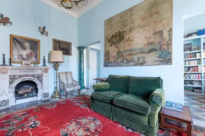 a living room with a green couch and a fireplace at Residenza Prati - ZEN24 in Rome