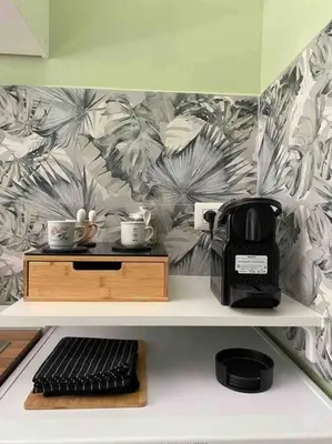 a shelf with a coffee maker and cups on it at Carpegna42 in Rome