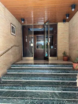 a building with stairs leading to a revolving door at Carpegna42 in Rome