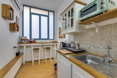 a kitchen with a sink and a microwave at Gladiator's House in Rome