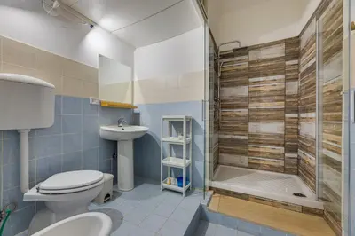a bathroom with a toilet and a shower and a sink at Gladiator's House in Rome