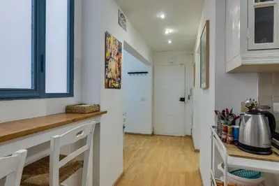 a kitchen with white walls and a wooden counter top at Gladiator's House in Rome