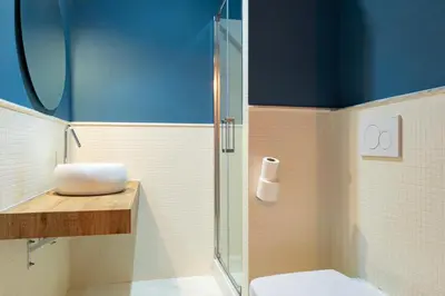 a bathroom with a glass shower and a toilet at Rdr Tortona Rooms in Rome