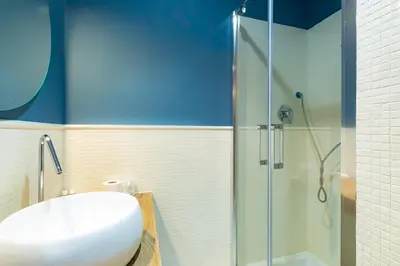 a bathroom with a sink and a glass shower at Rdr Tortona Rooms in Rome