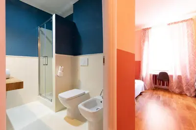 a bathroom with a white sink and a mirror at Rdr Tortona Rooms in Rome