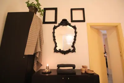 a room with a mirror and a table with a candle at I Colori di Nini Vacanza a Trastevere in Rome