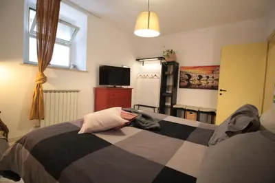 a bedroom with a bed and a television in it at I Colori di Nini Vacanza a Trastevere in Rome