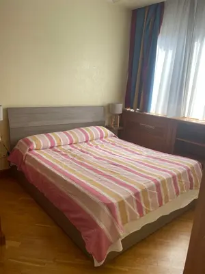 a bed with a striped blanket in a bedroom at Casa vacanze al 315 a San Giovanni in Rome