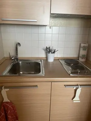 a kitchen counter with a sink and a stove at Casa vacanze al 315 a San Giovanni in Rome