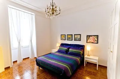 a bedroom with a bed and a chandelier at Il Limone A San Pietro in Rome