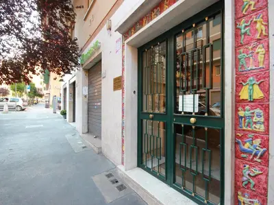 a store front with a green door on a street at Le Piazze Di Roma in Rome
