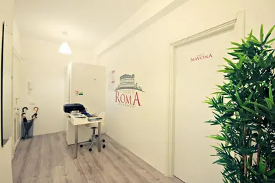 an office with a desk and a sign on a wall at Le Piazze Di Roma in Rome