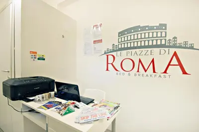 a table with a printer and a sign on a wall at Le Piazze Di Roma in Rome