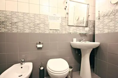 a small bathroom with a toilet and a sink at Le Piazze Di Roma in Rome