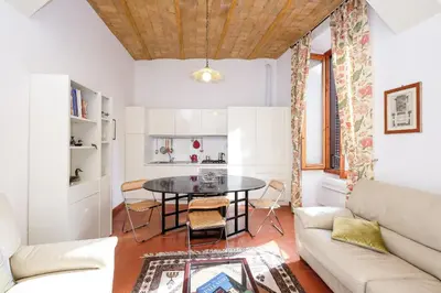 a living room with a table and a couch at Trastevere Charming Retreat on Cobblestone Street in Rome
