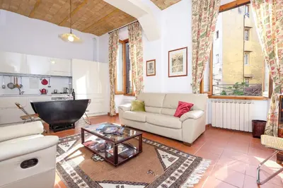 a living room with a couch and a table at Trastevere Charming Retreat on Cobblestone Street in Rome