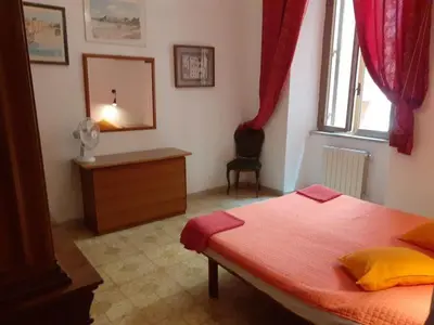 a bedroom with a bed and a dresser and a mirror at Il Pretoriano in Rome