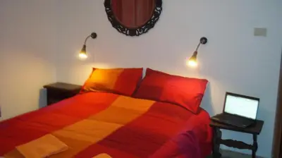 a bedroom with a bed with two lamps and a laptop at Il Pretoriano in Rome