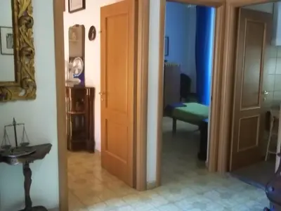 a hallway with a door and a room with a couch at Il Pretoriano in Rome