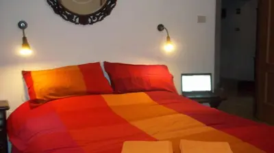 a bedroom with a colorful bed with a mirror on the wall at Il Pretoriano in Rome