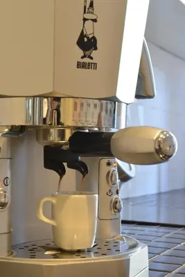 a coffee maker is making a cup of coffee at Maison Flaminio in Rome