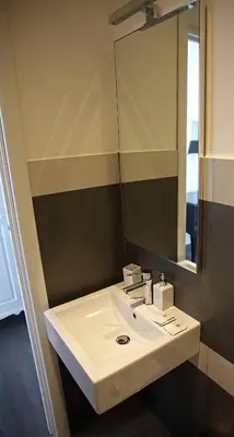 a bathroom with a white sink and a mirror at Maison Flaminio in Rome