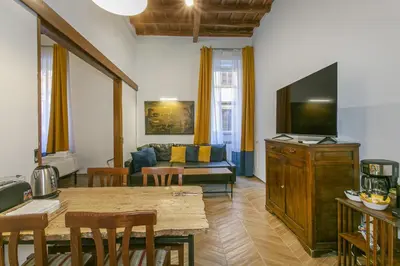 a living room with a television and a table and chairs at Trevi Little Palace #2 in Rome