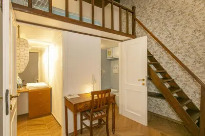 a room with a desk and a loft bed at Trevi Little Palace #2 in Rome