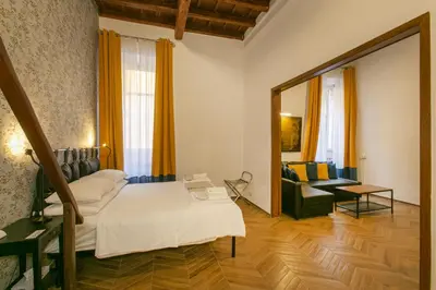 a bedroom with a bed and a mirror at Trevi Little Palace #2 in Rome