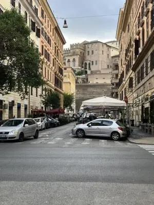 a street with cars parked on the side of the road at Cactus2023 in Rome