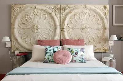 a bedroom with a large bed with a large headboard at Beautiful apartment with amazing Rooftop&Jacuzzi in Rome