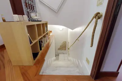 a stairway with a book shelf and a stair case at Beautiful apartment with amazing Rooftop&Jacuzzi in Rome