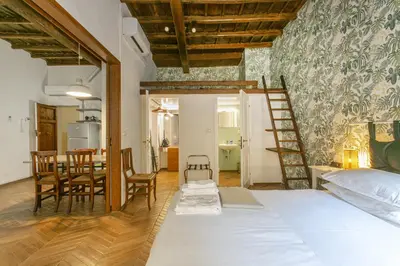 a bedroom with a bed and a dining room at Trevi Little Palace #4 in Rome