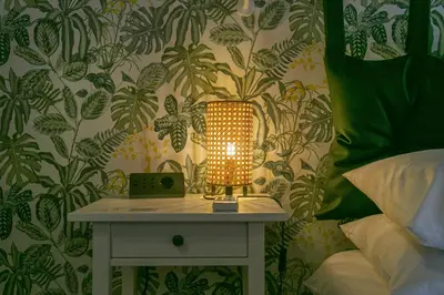 a lamp on a table next to a bed at Trevi Little Palace #4 in Rome