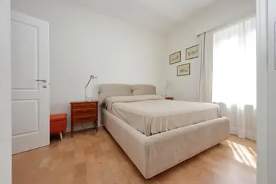 a bedroom with a bed and a table and a window at Anita in Rome