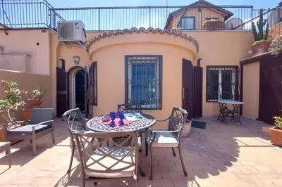 a patio with a table and chairs in front of a house at Anita in Rome