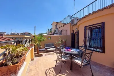 a patio with a table and chairs on a balcony at Anita in Rome