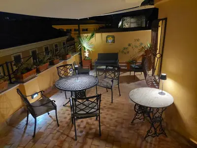 a room with tables and chairs and a patio at Anita in Rome