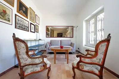 a living room with two chairs and a table at Anita in Rome