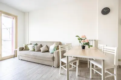 a living room with a couch and a table at Urban Retreat -private parking+terrace in Rome