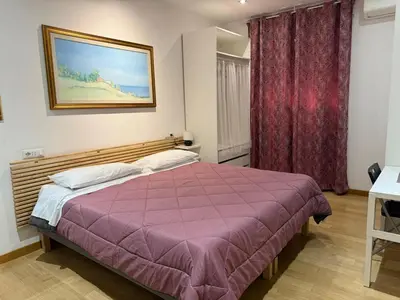 a bedroom with a bed with a purple blanket at Appartamento Garbatella in Rome