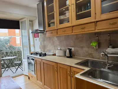 a kitchen with a sink and a stove at Appartamento Garbatella in Rome