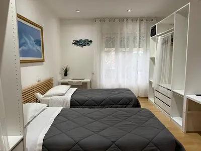 a bedroom with two beds and a window at Appartamento Garbatella in Rome