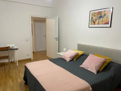a bedroom with a bed with two pink pillows at LOCAZIONE TURISTICA PAOLUCCI in Rome